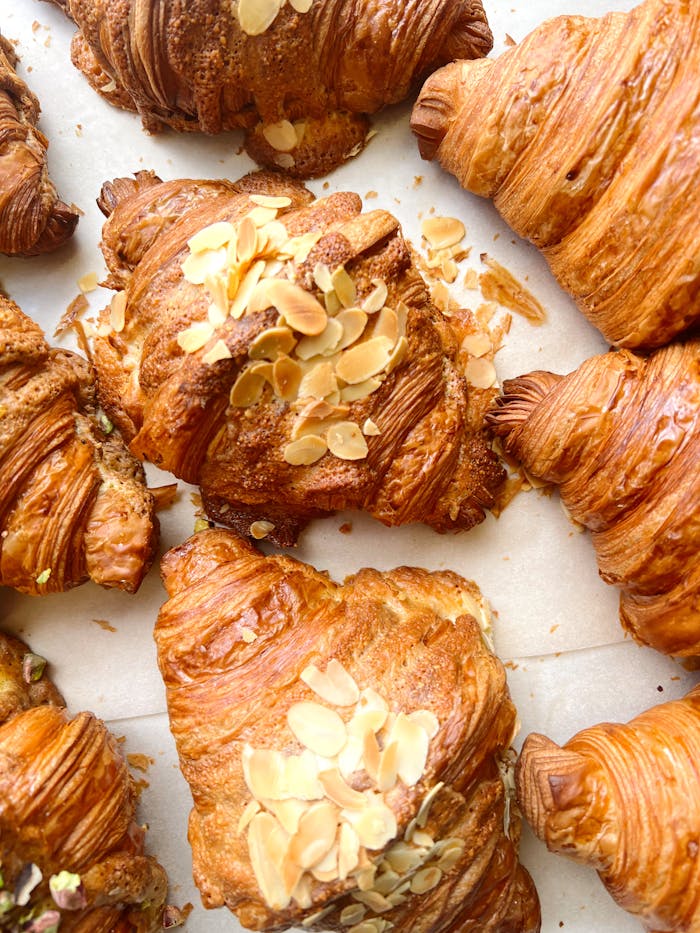 Tempting almond-topped croissants showcasing golden layers.